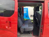 a red van that has a blue seat in the back