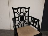 a black chair with a tan cushion on it