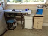 an image of a kitchen with a table and a refrigerator