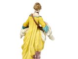 pair of porcelain figurines of a woman and a dog