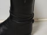 a close up of a pair of black boots on the floor