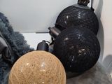 a ball of yarn on a pillow next to a lamp