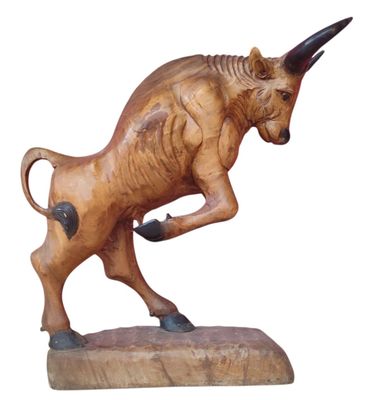 statue of a bull on a wooden base on a white background