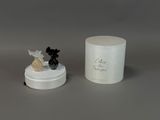 a small figurine of a dog and a candle on a table