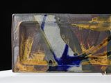 a glass plate with a painting on it on a table
