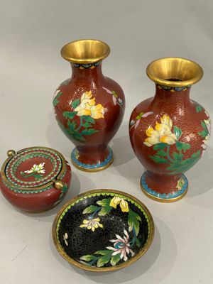 three vases and a bowl are sitting on a white surface
