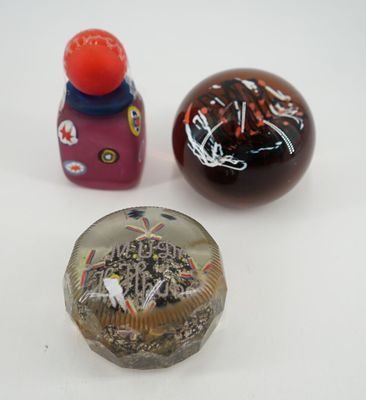 trois petits objets en verre posés sur une surface blanche