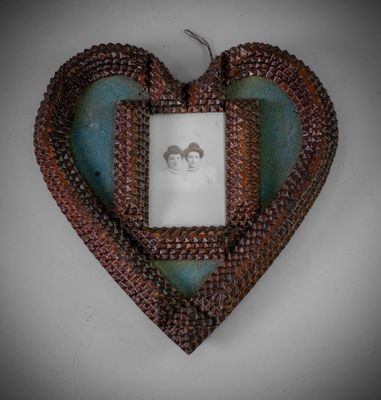 a picture of a heart shaped picture frame hanging on a wall