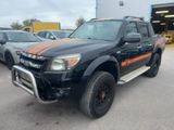 a picture of a black truck with orange stripes parked in front of a building