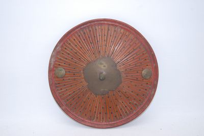 a picture of a red plate on a white wall