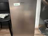 a silver refrigerator sitting in the corner of a room