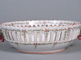 a white bowl with red berries in it on a table
