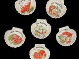 six ceramic plates with different types of food on them on a black background
