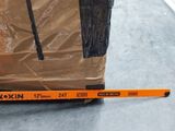 a box that is sitting on the floor next to a ruler