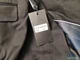 a close up of a suit and tie with a tag on it