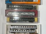 many different types of train cars in a display case