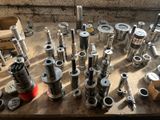 many different types of metal pipes and valves on a table