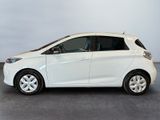 a picture of a small white car parked in a garage