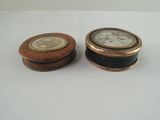 two wooden boxes with a clock on them on a white surface