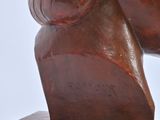 sculpture of a woman ' s head on a wooden base