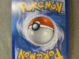 a close up of a card with a pokemon ball on it
