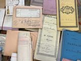 a pile of old papers and old books on the floor