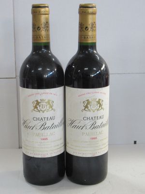 two bottles of wine sitting next to each other on a counter