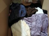 a cardboard box filled with clothes and other items