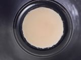 a cup of coffee in a black cup on a table