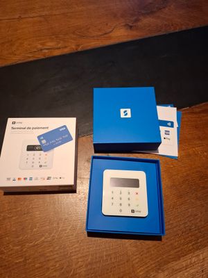 a blue box with a blue card inside of it on a wooden table