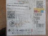 a cardboard box with a sticker on it sitting on the floor