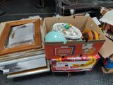 a pile of junk in a cardboard box on the floor
