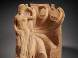 a roman marble relief of a seated woman