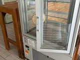 an image of a glass door refrigerator in a kitchen