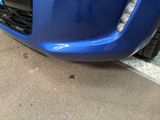 a blue car that is parked on the side of the road