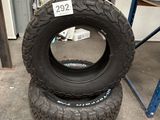 two tires are stacked on top of each other in a garage