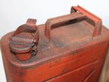 an old red metal box with a handle on it