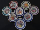 six plates with different designs on them sitting on a table