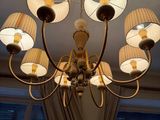 a chandelier with five lamps hanging from the ceiling