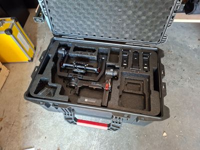 a hard case with tools inside of it on the floor