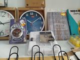 many different clocks and other items on the table