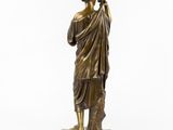 a bronze statue of a man holding a staff