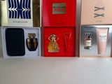 many different types of perfumes in boxes on a table