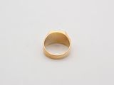 a close up of a gold ring on a white surface