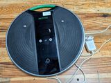a remote control on a record on a wooden floor