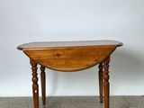 a small table with a wooden top on a carpeted floor