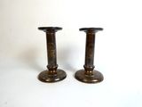 pair of antique brass candlesticks on a white background