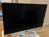 a computer monitor sitting on top of a wooden desk