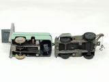 a toy train that is sitting next to another toy train