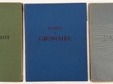 three books are lined up in a row on a white surface